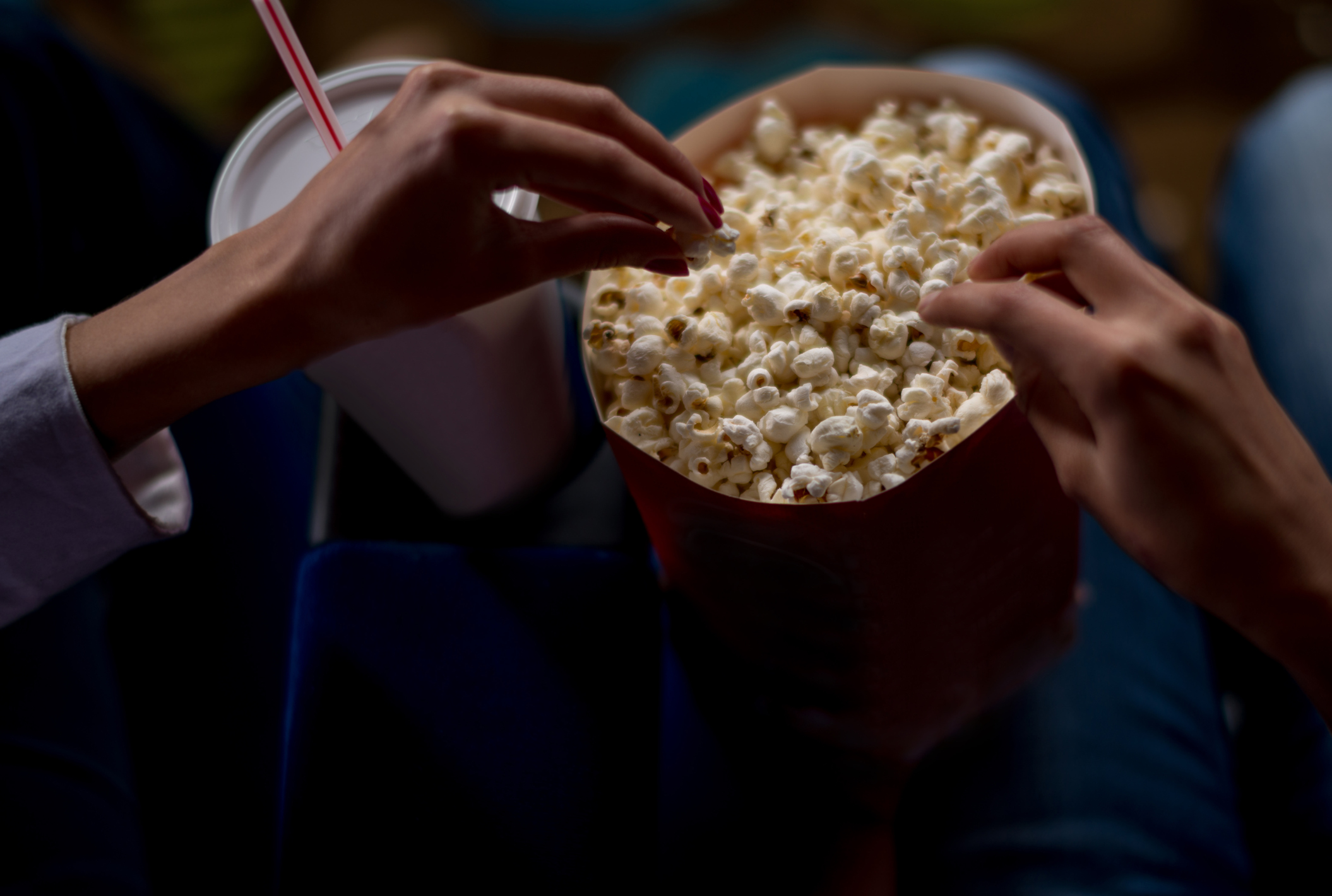 Unrecognisable people eating popcorn at the movies